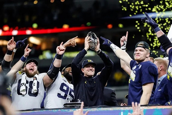 Andrew Vastardis (68), Donovan Jeter (95), Jim Harbaugh, Aidan Hutchinson (97), and Big Ten Conference Championship Trophy