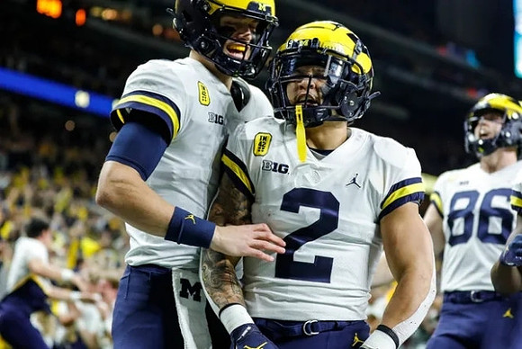 J.J. McCarthy (9), Blake Corum (2), and Luke Schoonmaker (86)