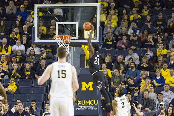 Jon Teske (15) and Zavier Simpson (3)