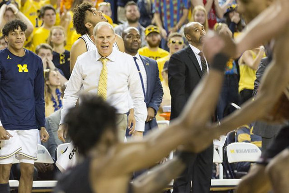 Eli Brooks (55), John Beilein, and Saddi Washington
