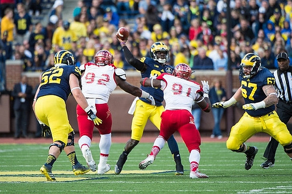 Mason Cole (52), Devin Gardner (98), and Kyle Kalis (67)