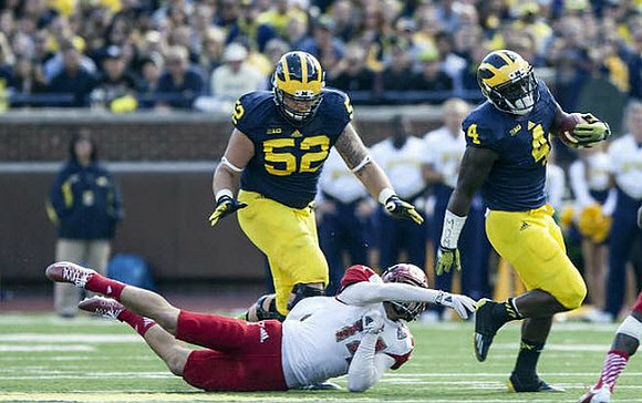 Mason Cole (52) and De'Veon Smith (4)