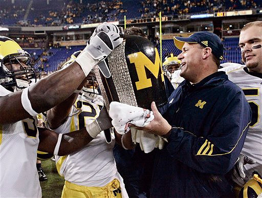 Stevie Brown (3), Brandon Harrison (27), and Rich Rodriguez