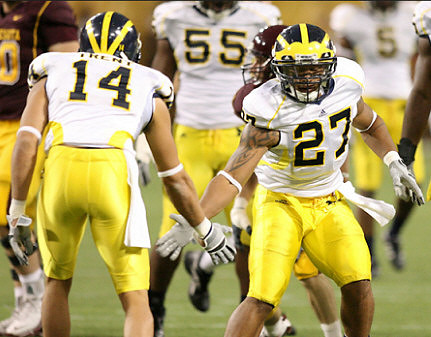 Morgan Trent (14), Brandon Harrison (27), and Brandon Graham (55)