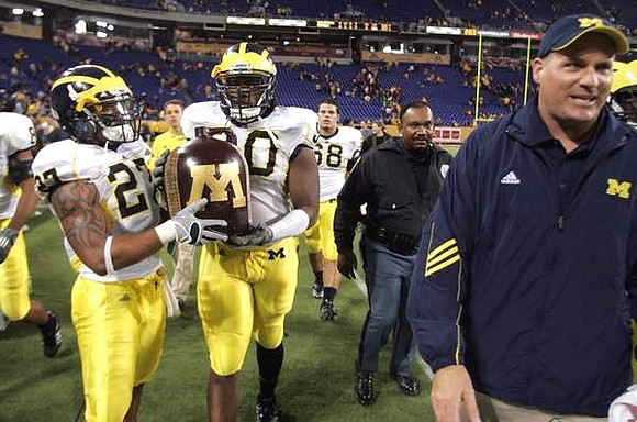 Brandon Harrison (27), Michael Shaw (20), Rich Rodriguez, and the Little Brown Jug