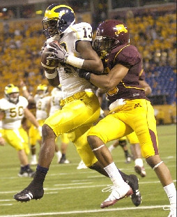 Greg Mathews (13) and David Molk (50)
