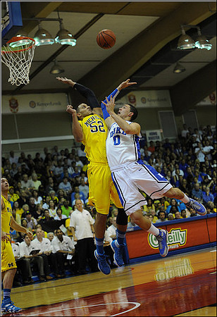 Zack Novak (0), Jordan Morgan (52), and John Beilein