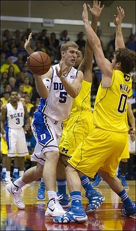 Zack Novak (0) and Jon Horford (15)