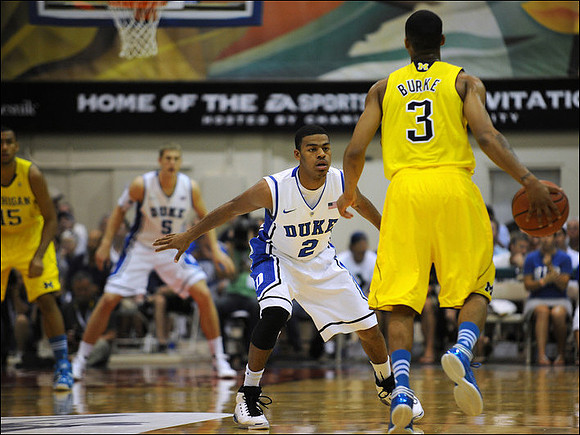 Jon Horford (15) and Trey Burke (3)