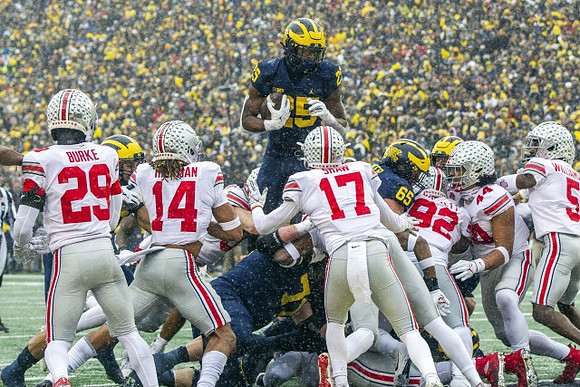 Andrew Stueber (71), Hassan Haskins (25), and Zak Zinter (65)