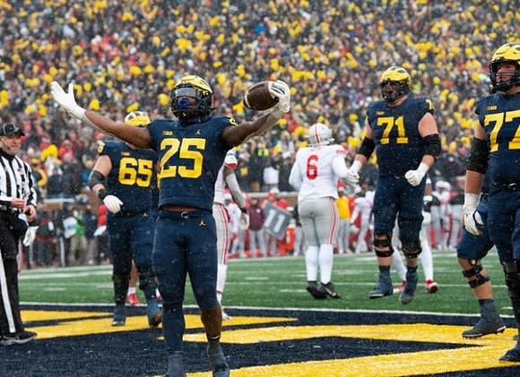 Zak Zinter (65), Hassan Haskins (25), Andrew Stueber (71), and Trevor Keegan (77)