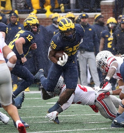 Cade McNamara (12) and Hassan Haskins (25)