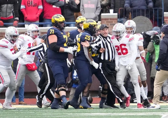 Andrew Stueber (71), Luke Schoonmaker (86), and Hassan Haskins (25)