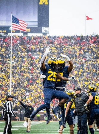 Hassan Haskins (25), Donovan Edwards (7), Roman Wilson (14), Jim Harbaugh, and Erick All (83)