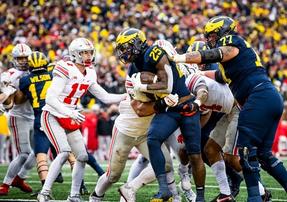 Roman Wilson (14), Hassan Haskins (25), and Trevor Keegan (77)