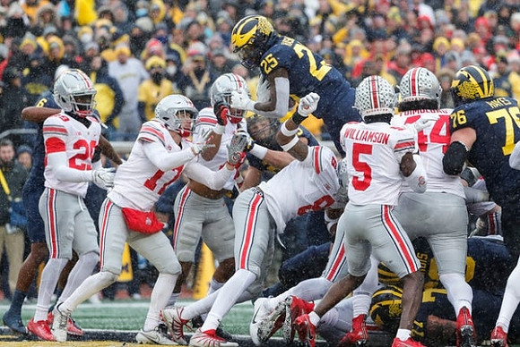 Hassan Haskins (25) and Ryan Hayes (76)