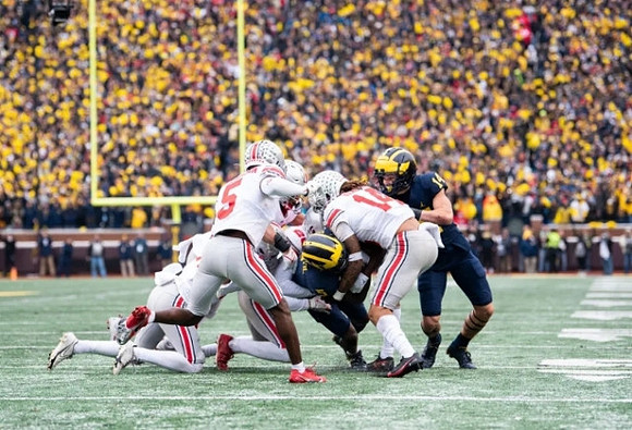 Mike Sainristil (5) and Roman Wilson (14)
