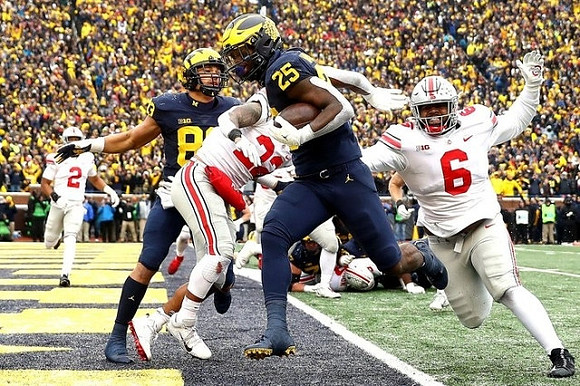 Erick All (83) and Hassan Haskins (25)