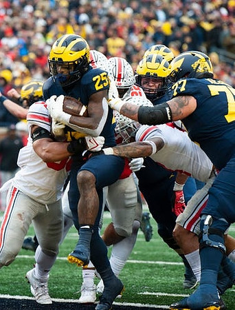 Hassan Haskins (25) and Trevor Keegan (77)