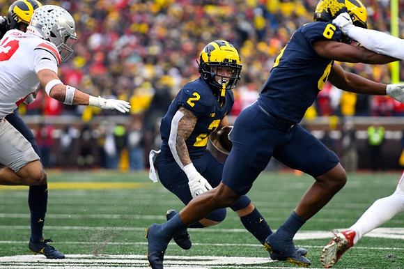 Blake Corum (2) and Cornelius Johnson (6)
