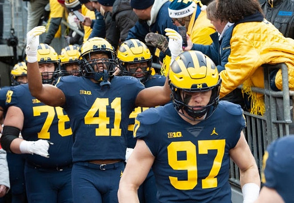 Aidan Hutchinson (97), Nikhai Hill-Green (41), and Griffin Korican (78)