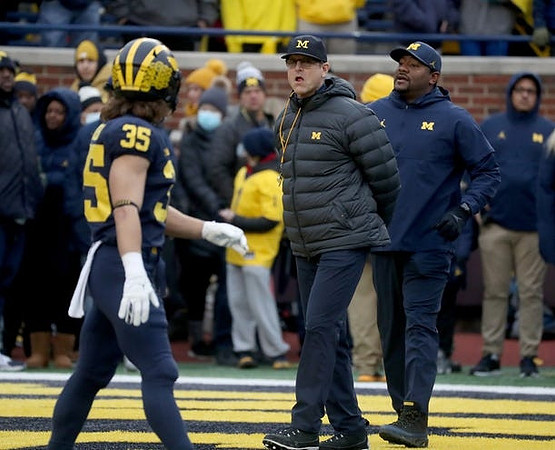 Caden Kolesar (35), Jim Harbaugh, and Ron Bellamy
