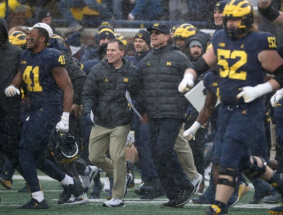 Nikhai Hill-Green (41), Jim Harbaugh, and Karsen Barnhart (52)
