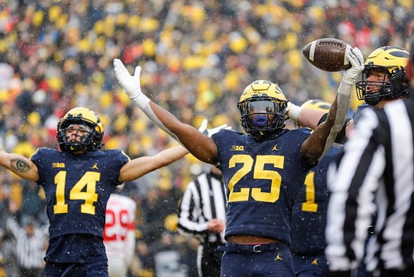 Roman Wilson (14) and Hassan Haskins (25)