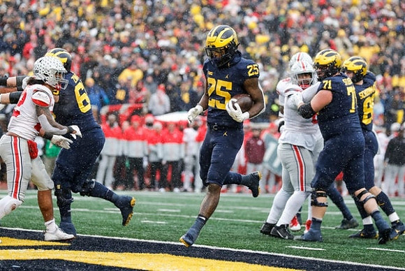 Zak Zinter (65), Hassan Haskins (25), Andrew Stueber (71), and Luke Schoonmaker (86)