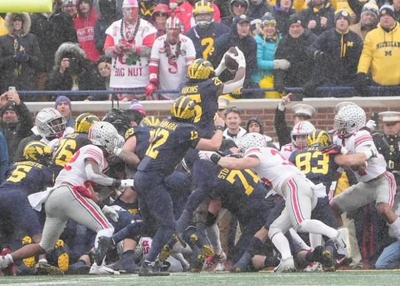 Mike Sainristil (5), Ryan Hayes (76), Zak Zinter (65), Cade McNamara (12), Hassan Haskins (25), and Andrew Stueber (71)