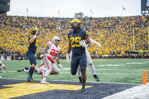 Erick All (83) and Hassan Haskins (25)
