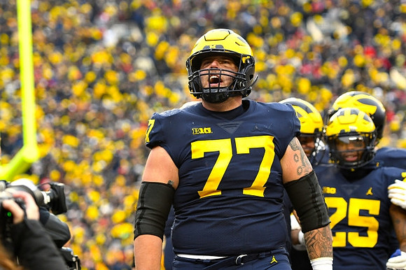 Trevor Keegan (77) and Hassan Haskins (25)
