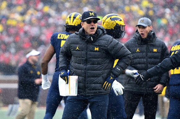 Donovan Edwards (7) and Jim Harbaugh