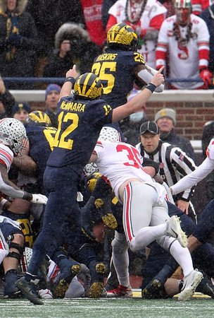 Cade McNamara (12) and Hassan Haskins (25)