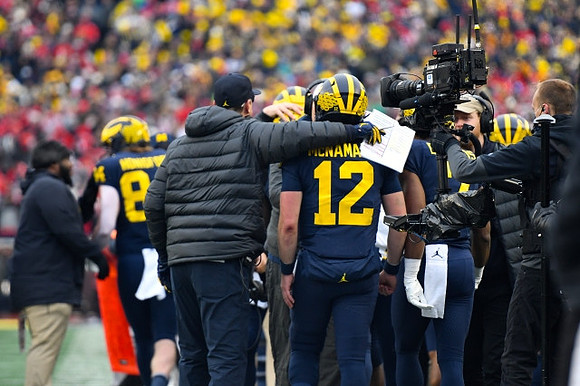 Joel Honigford (84), Jim Harbaugh, and Cade McNamara (12)