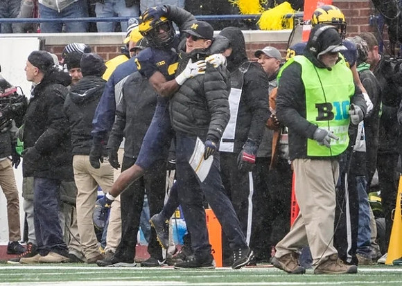 A.J. Henning (3) and Jim Harbaugh