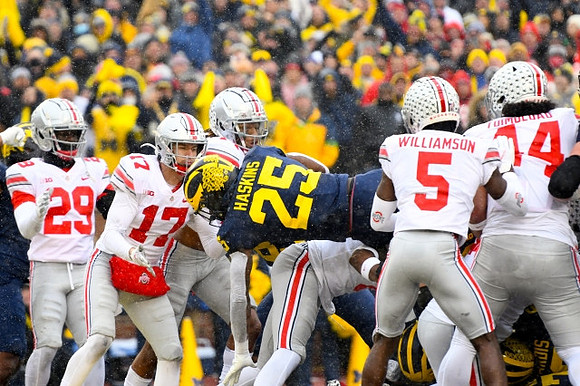 Hassan Haskins (25) and Andrew Vastardis (68)