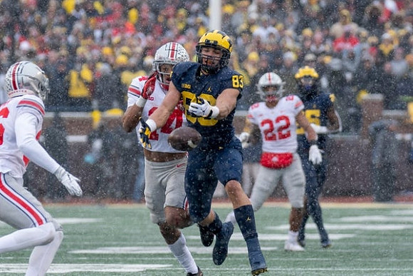 Erick All (83) and Hassan Haskins (25)