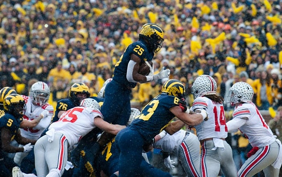 Mike Sainristil (5), Ryan Hayes (76), Hassan Haskins (25), Trevor Keegan (77), and Erick All (83)