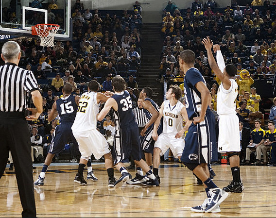 Jordan Morgan (52), Zack Novak (0), and Darius Morris (4)
