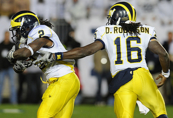 Vincent Smith (2) and Denard Robinson (16)