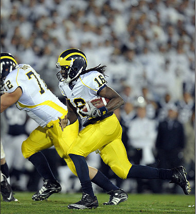 Mark Huyge (72) and Denard Robinson (16)