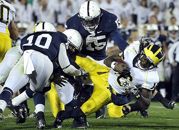 David Molk (50) and Denard Robinson (16)