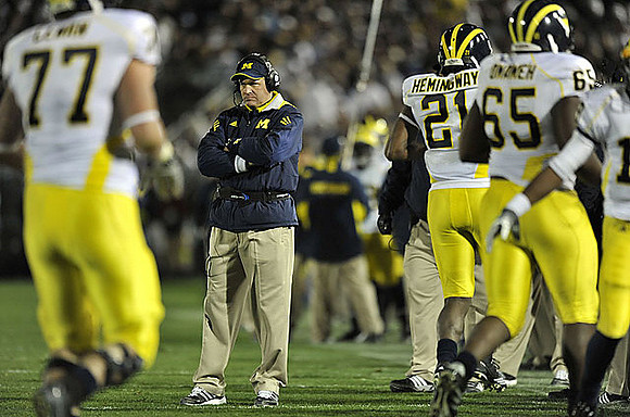 Taylor Lewan (77), Rich Rodriguez, Junior Hemingway (21), and Patrick Omameh (65)