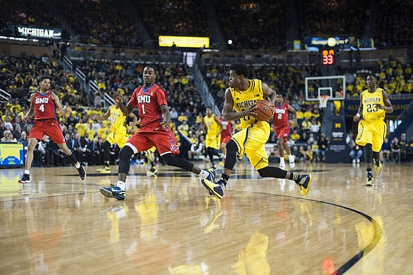 Derrick Walton Jr. (10), Zak Irvin (21), and Caris LeVert (23)