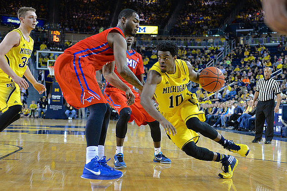 Mark Donnal (34) and Derrick Walton Jr. (10)