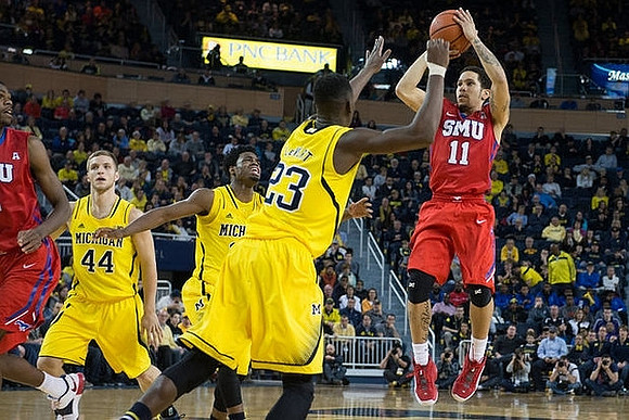 Max Bielfeldt (44), Derrick Walton Jr. (10), and Caris LeVert (23)