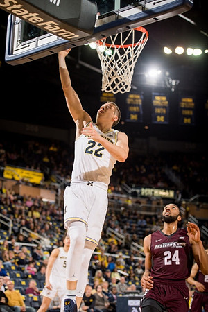 Duncan Robinson (22) and D.J. Wilson (5)