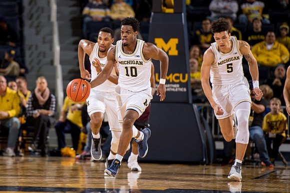Zak Irvin (21), Derrick Walton Jr. (10), and D.J. Wilson (5)