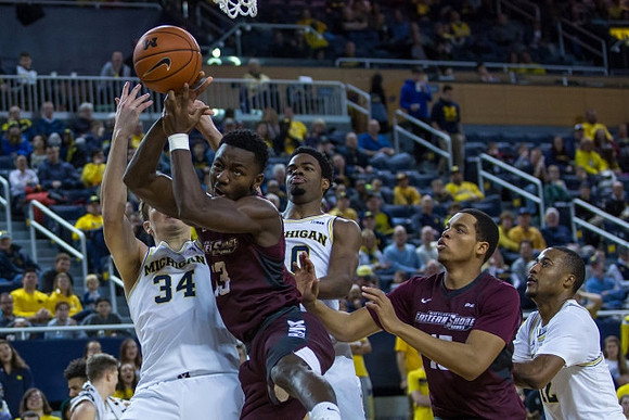 Mark Donnal (34), Derrick Walton Jr. (10), and Muhammad-Ali Abdur-Rahkman (12)